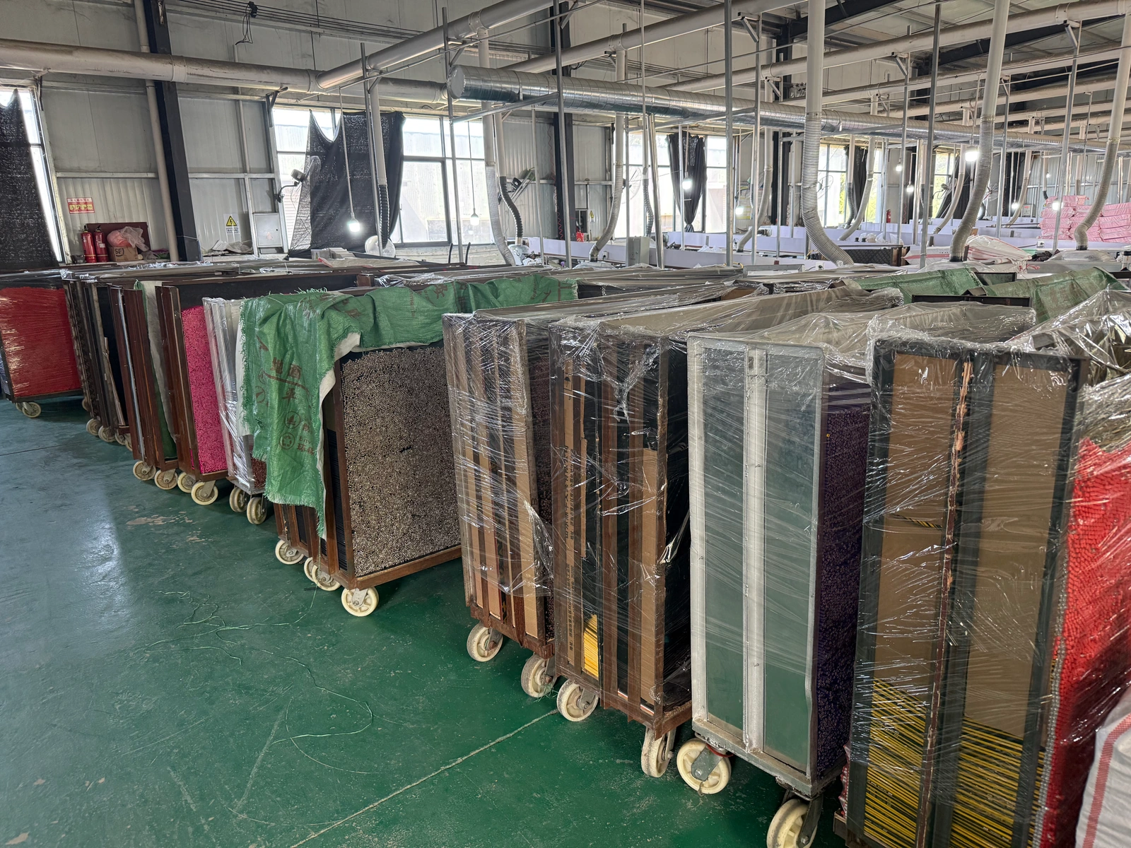 Company-archive photograph of pencil bodies in racks inside a production workshop